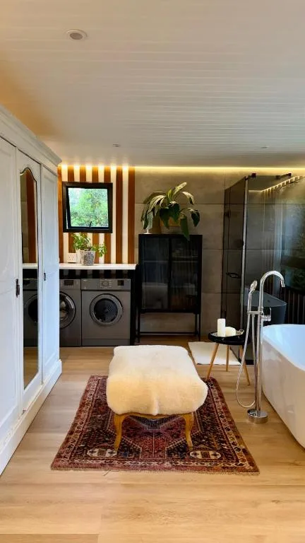 Modern bathroom with freestanding tub, dual vanity, and rainfall shower