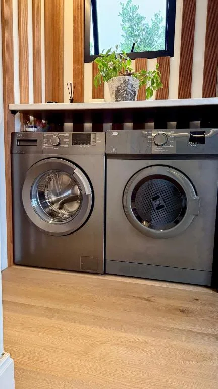 Modern laundry room with side-by-side washing and drying machines