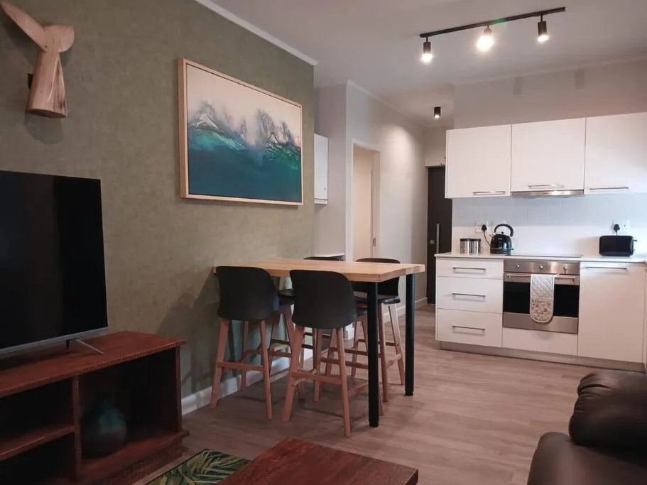 Open-plan dining area with bar seating and modern kitchen setup