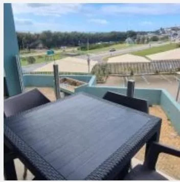 Outdoor table on balcony overlooking vineyard and lagoon landscape
