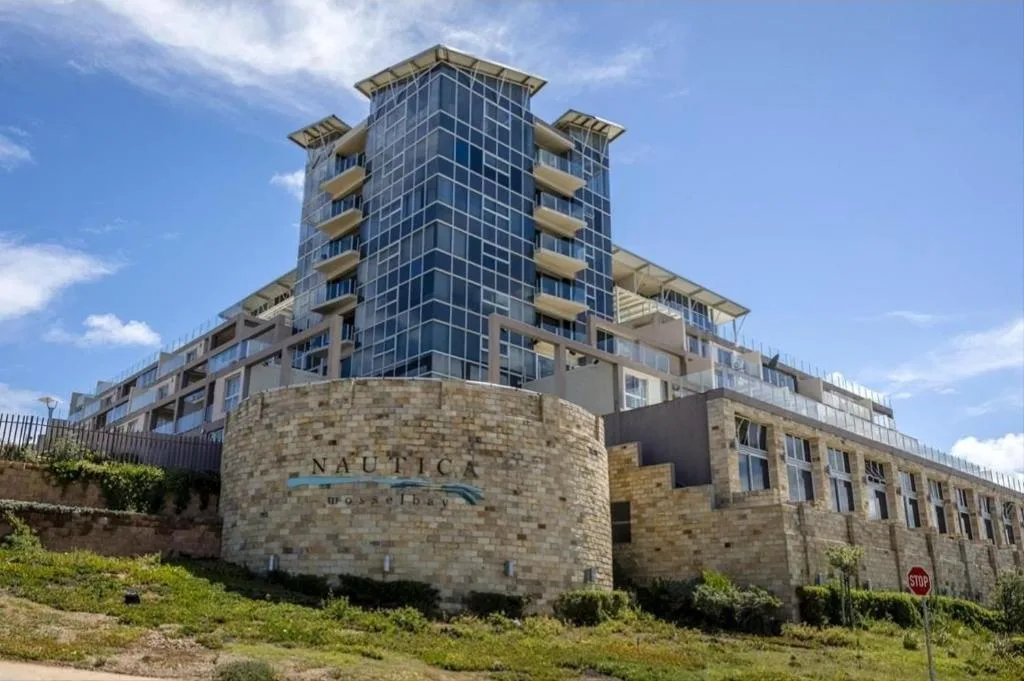 Modern multi-story apartment building with distinctive architecture and balconies