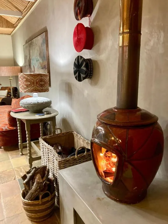 Decorative interior featuring a glowing red wood stove and woven baskets