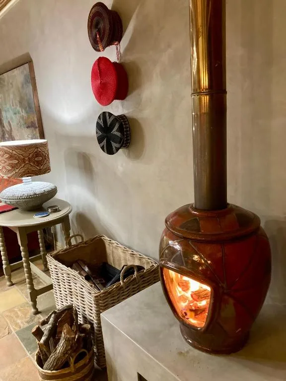 Decorative hats and wood stove with warm interior accents