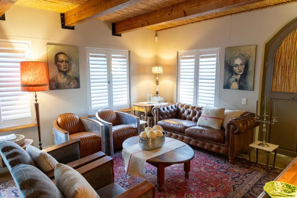 Elegant living room with leather Chesterfield sofa and coordinating armchairs
