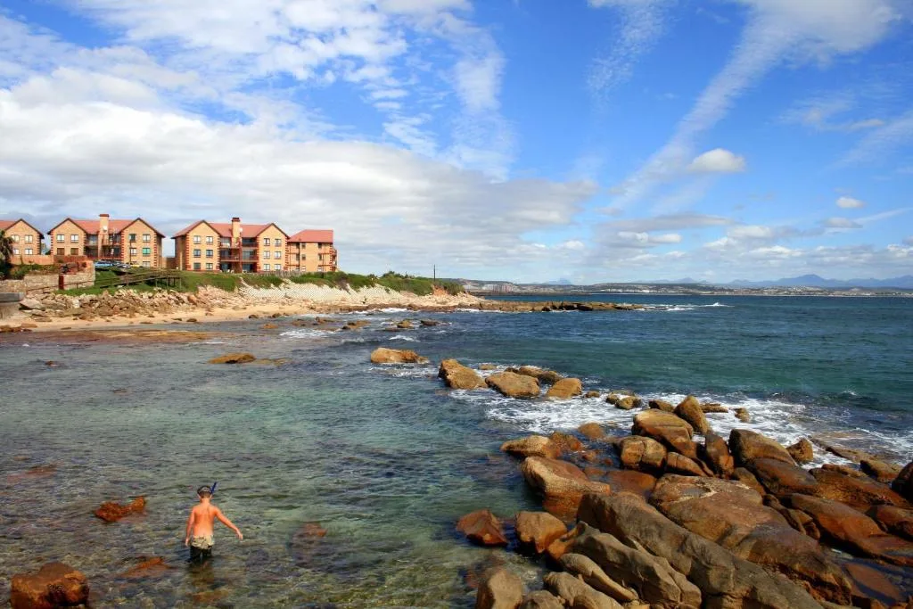 Beachfront accommodation with ocean view and rocky coastline below