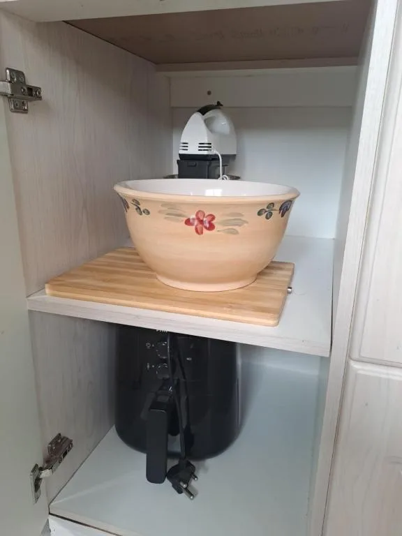 Decorative ceramic basin sink with floral design on wooden stand