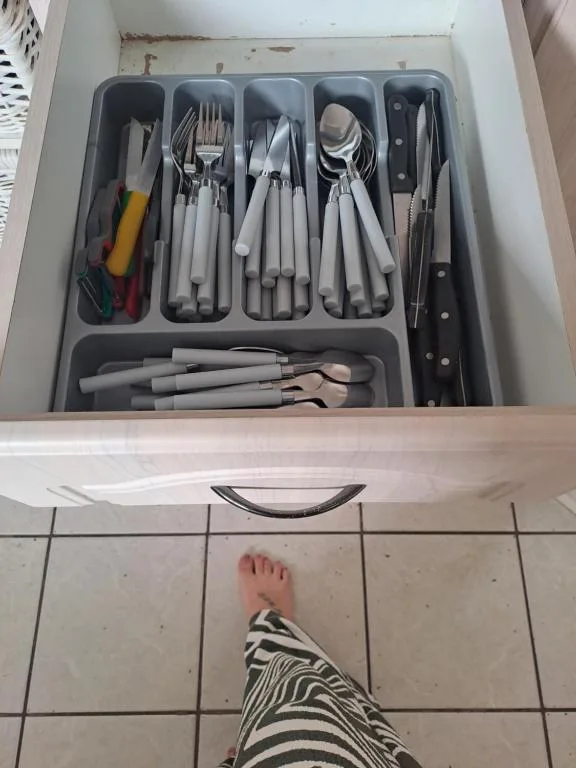Kitchen drawer organizer with cutlery, utensils and cooking tools neatly arranged