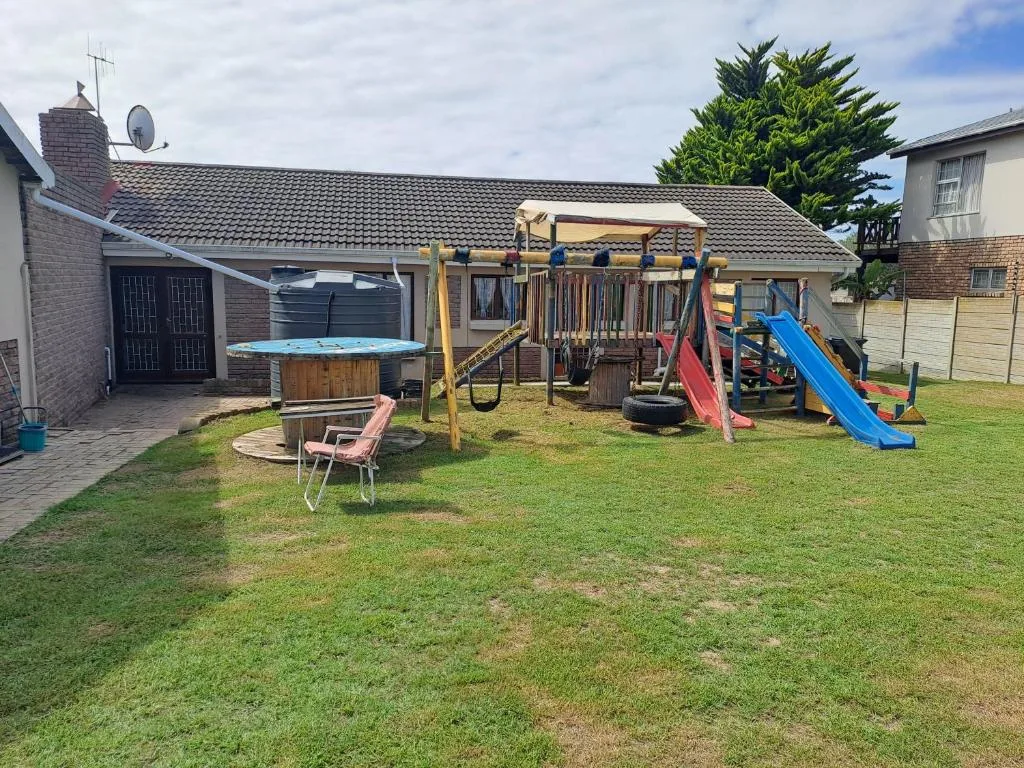 Family home with children's playground and braai area in grassy garden
