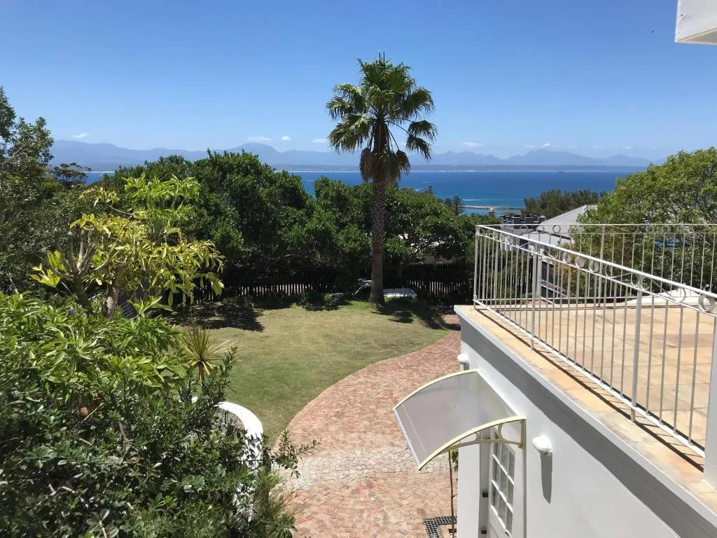 Scenic coastal vista with mountains and blue ocean visible from property garden