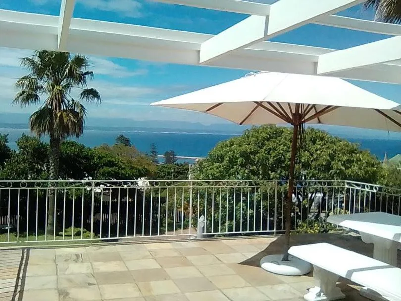 Elevated deck with umbrellas overlooking ocean and coastline views