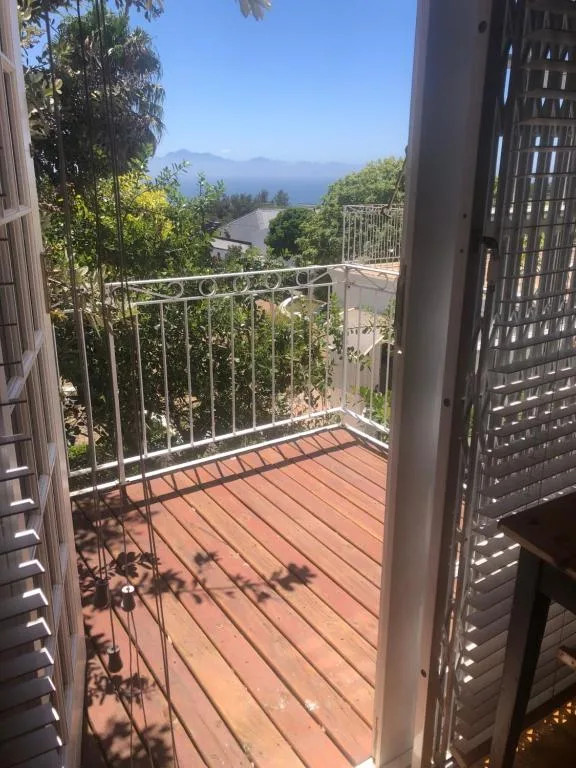 Scenic coastal lagoon and mountain view from wooden deck balcony