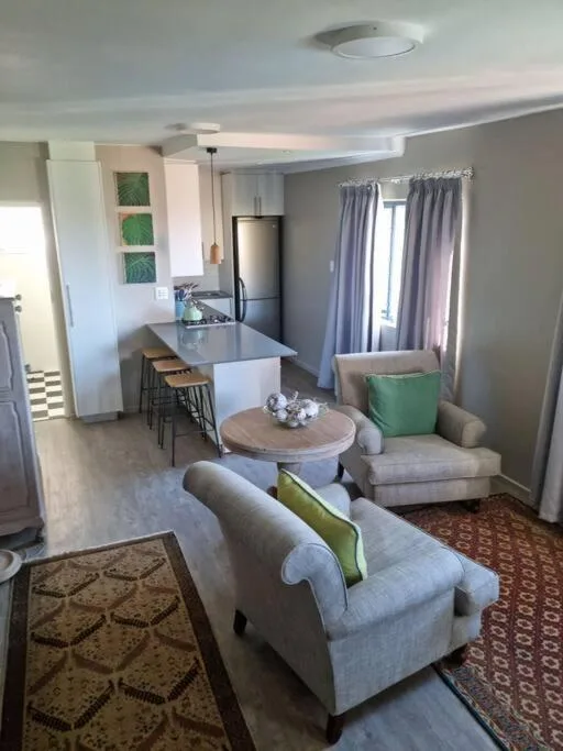 Open-plan living area with comfortable seating and modern kitchen island