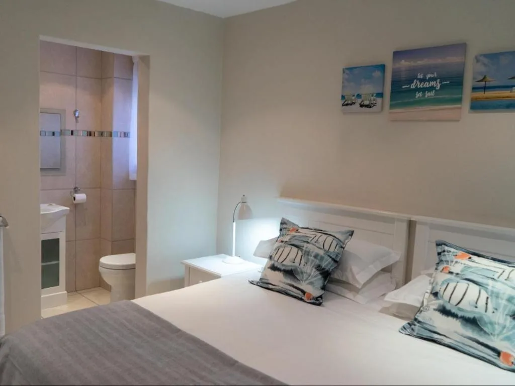 Bright bedroom with double bed and en-suite bathroom access visible