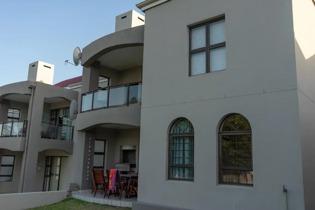 Modern apartment building facade with curved balconies and arched windows
