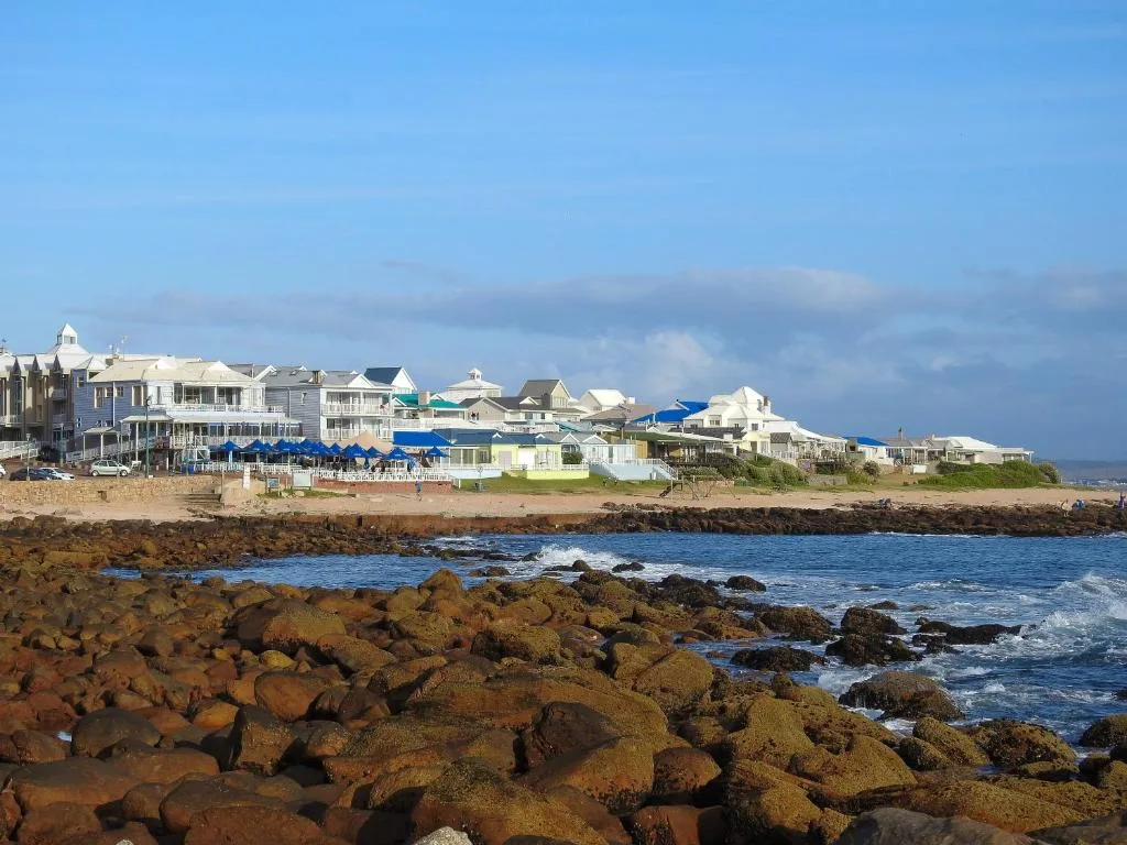 Beachfront properties with rocky coastline and ocean in foreground