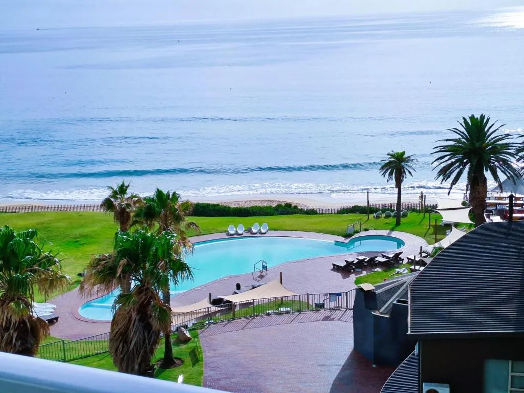 Ocean, beach, and pool view from beachfront property overlooking Garden Route