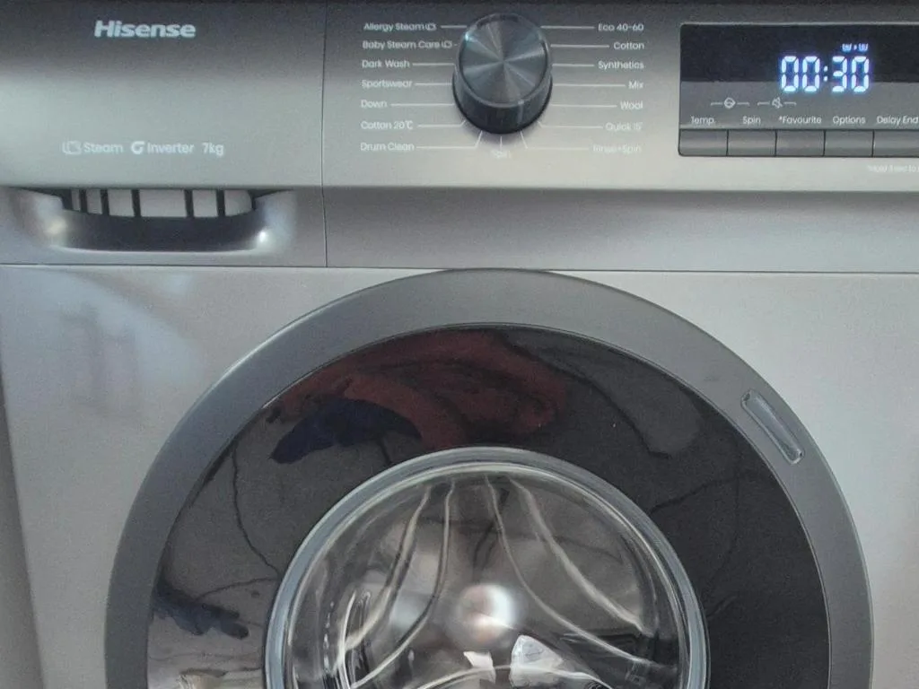Modern Hisense washing machine with steam function and digital controls