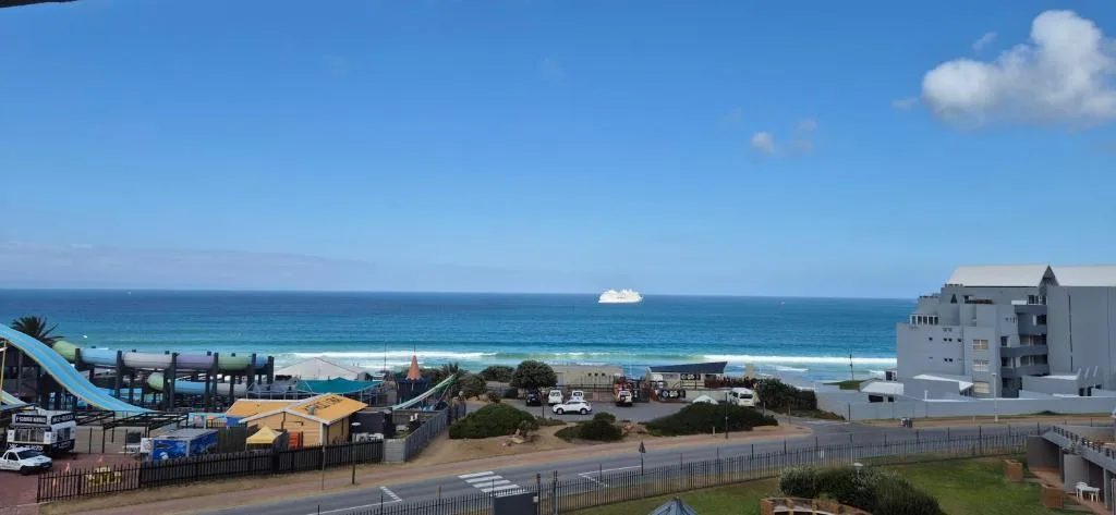 Ocean view with beach, pier, and coastal town infrastructure visible
