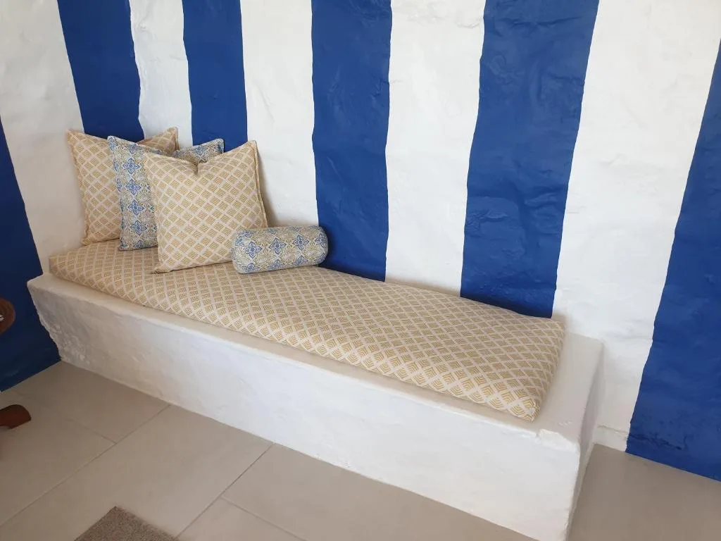 Built-in bench seating with striped blue and white nautical backdrop