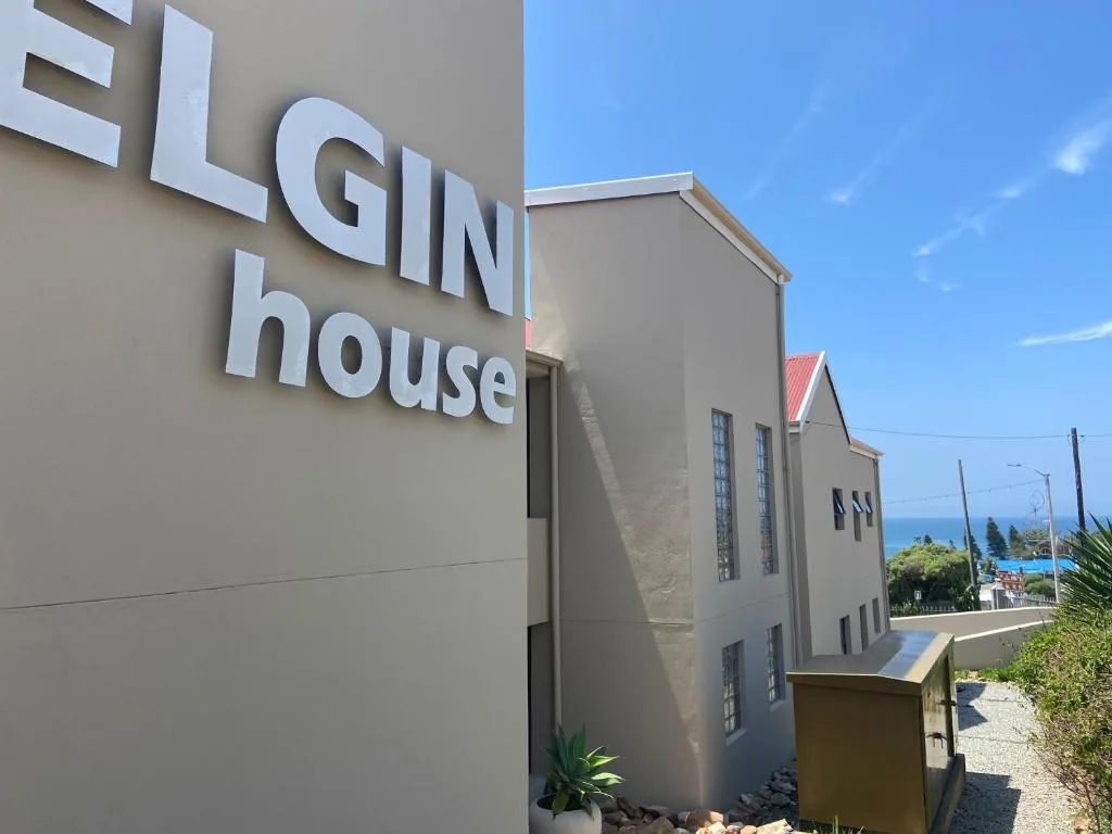 Modern beige building facade with Elgin House signage and ocean view