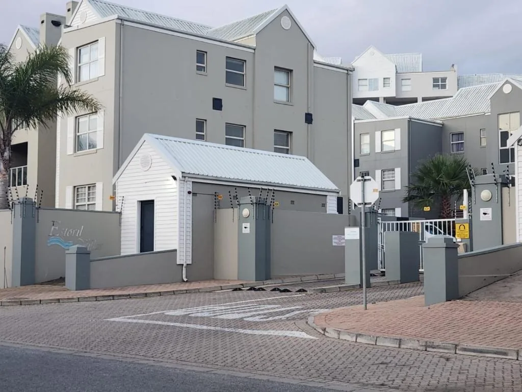 Modern multi-unit residential complex with gated entrance and paved courtyard