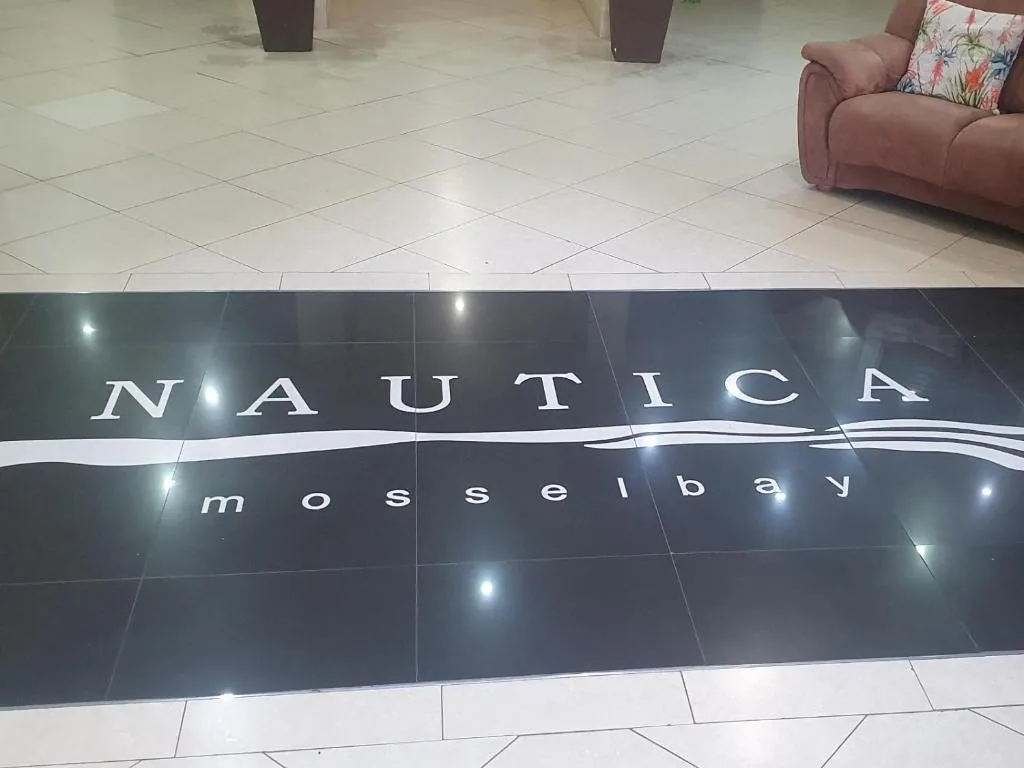Interior floor with Nautica Mossel Bay property name signage and lounge seating