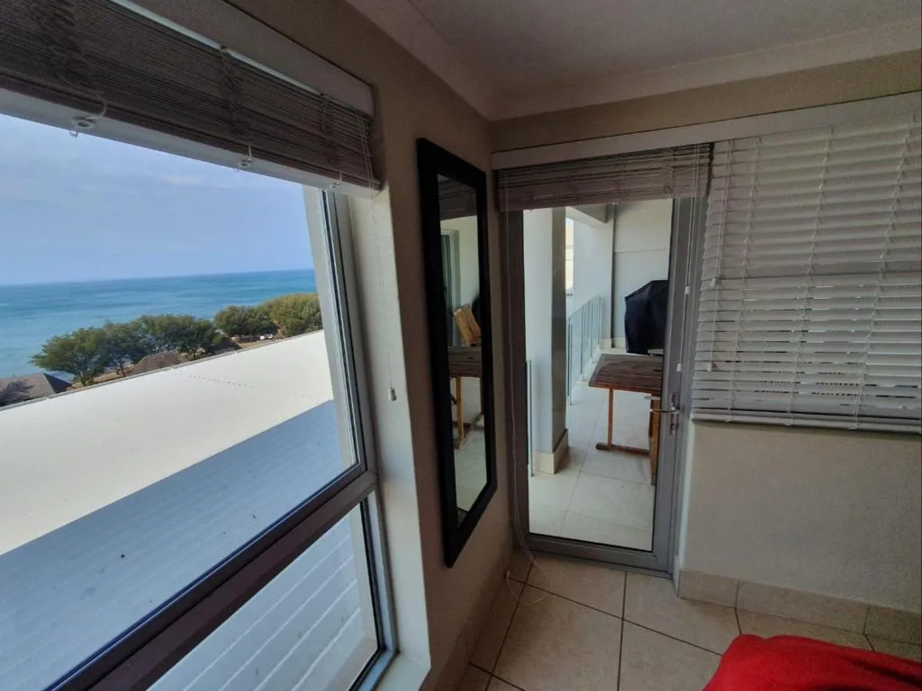Ocean and coastal landscape view from apartment balcony doors