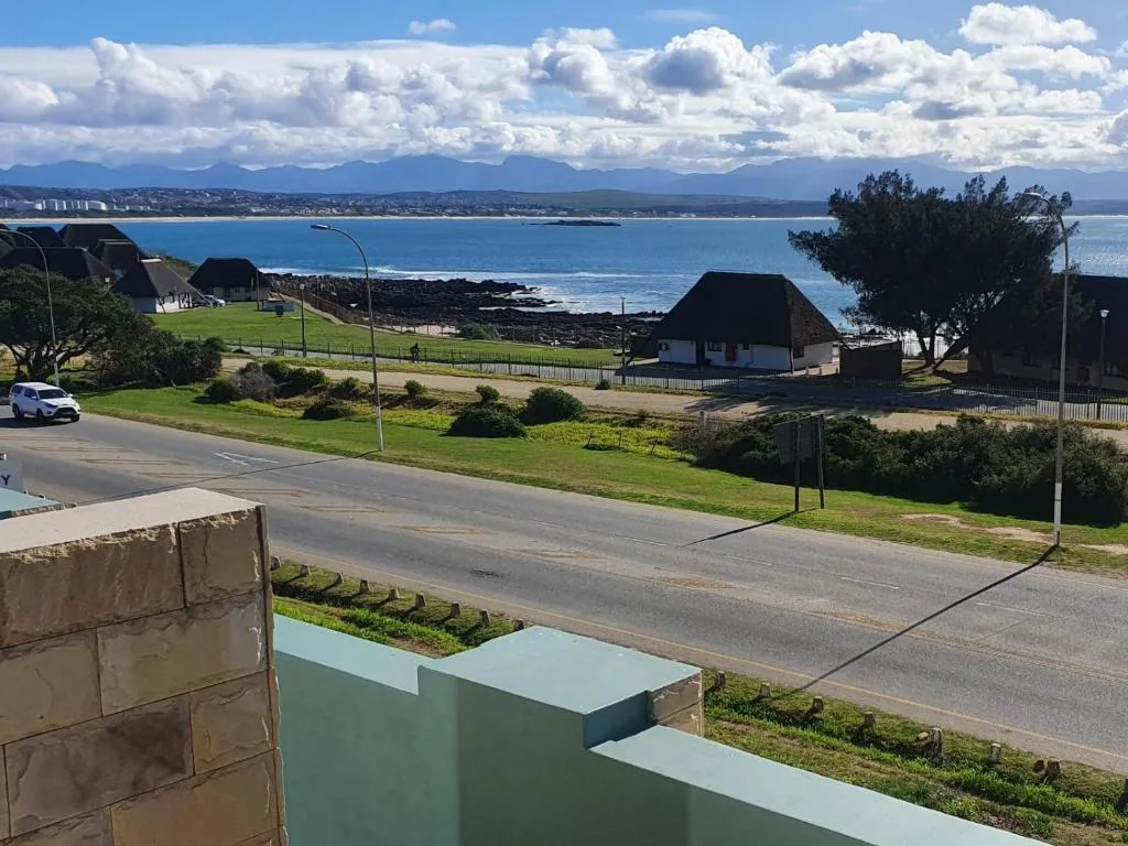 Panoramic coastal vista of Mossel Bay beach with mountains and blue ocean