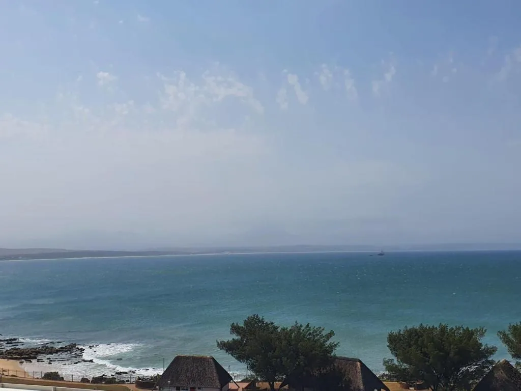 Expansive ocean view with turquoise waters and distant coastline visible