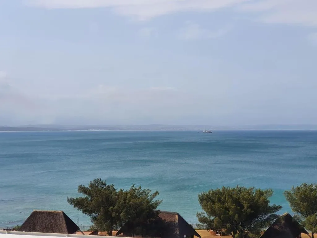 Expansive ocean view with turquoise waters and distant coastal landscape