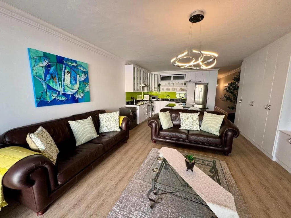 Modern lounge with brown leather sofas and contemporary pendant lighting