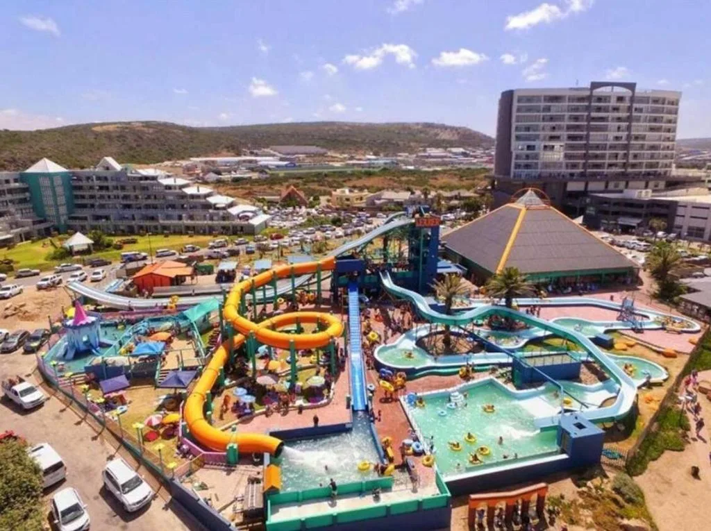 Aerial view of colorful water park with slides and pools below