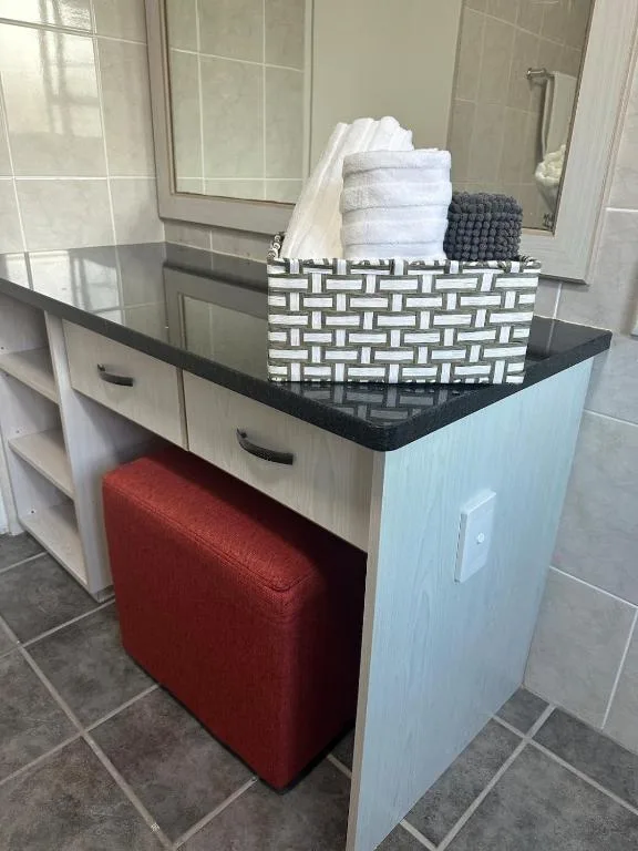 Bathroom vanity with storage basket and neatly folded towels displayed
