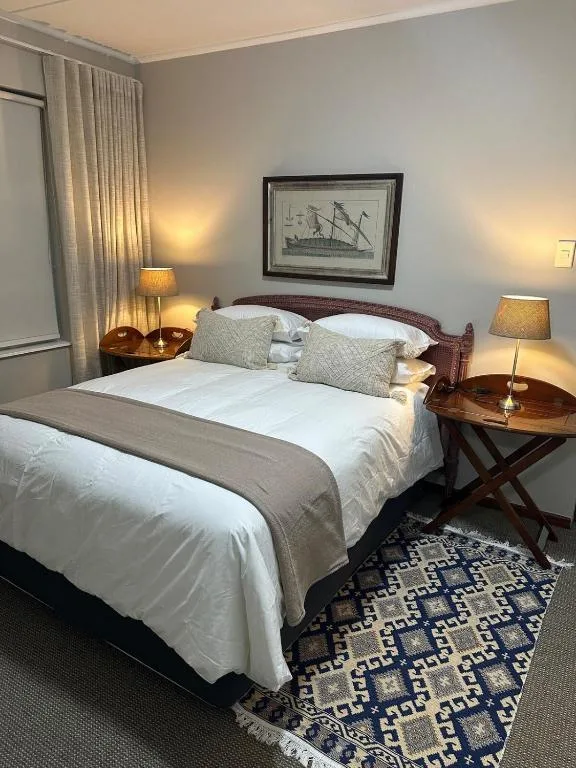 Elegantly furnished bedroom with double bed, bedside tables, and warm lighting