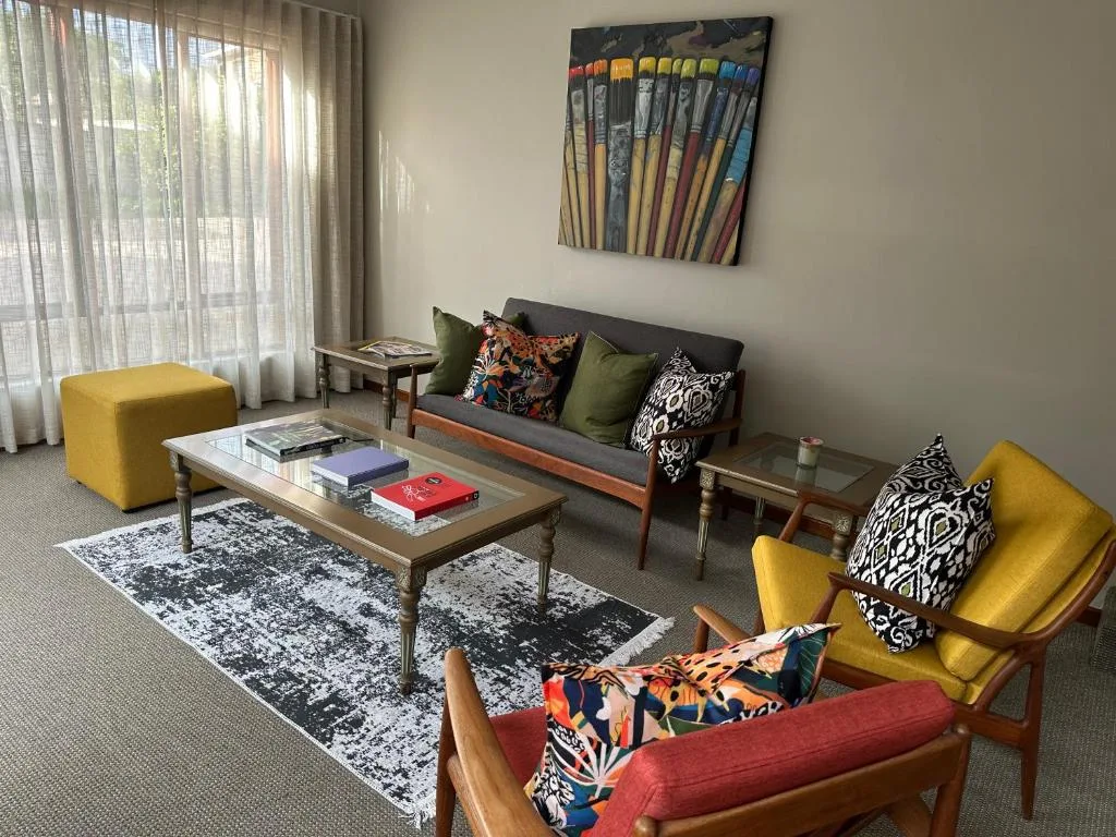 Bright lounge with colorful mid-century furniture and artistic decor