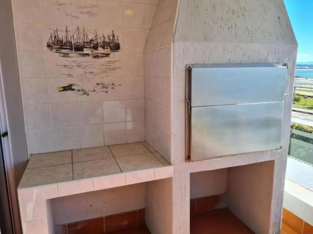 Tiled bathroom with bathtub, shower enclosure, and nautical wall art