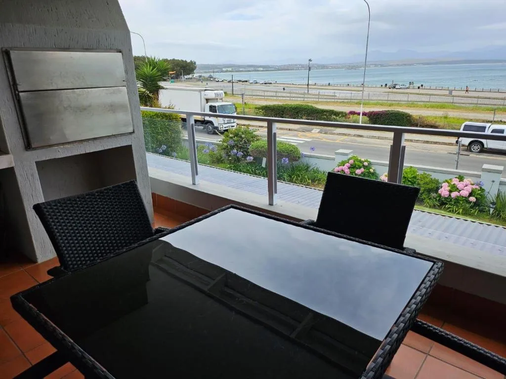 Outdoor balcony with seating overlooking beach and ocean view