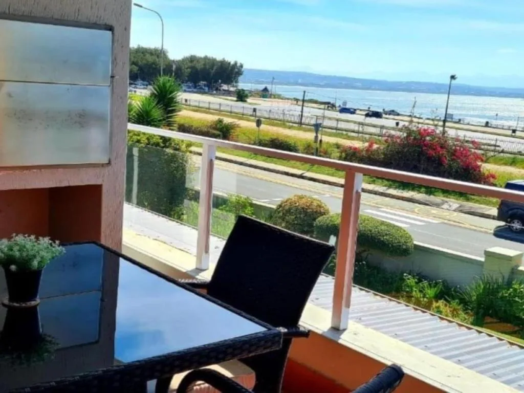 Panoramic lagoon and mountain vista from waterfront property balcony