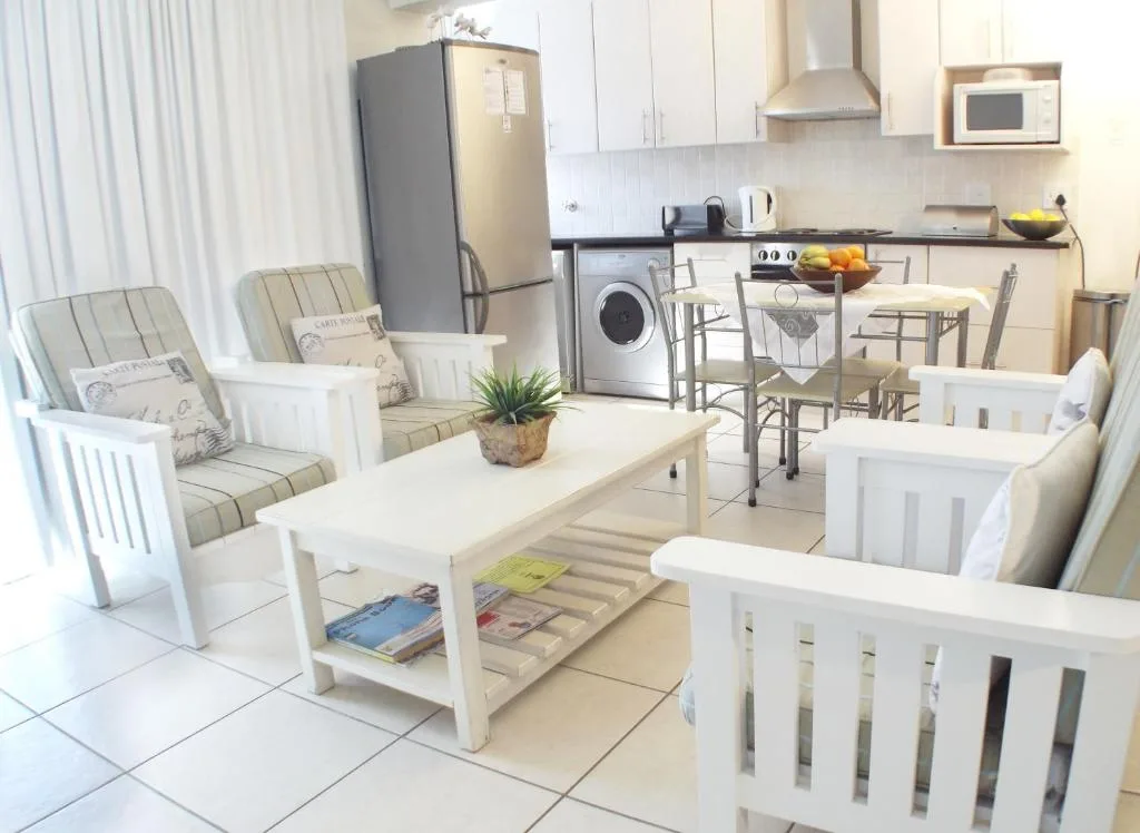Open-plan lounge and kitchen with comfortable seating and modern appliances