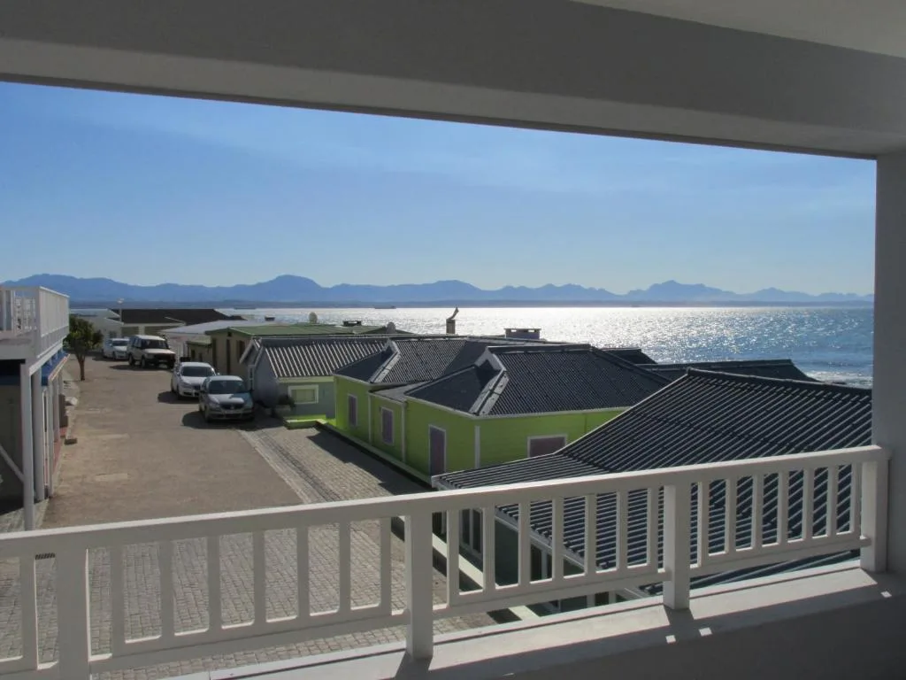 Scenic coastal view with mountains and sparkling ocean from property deck