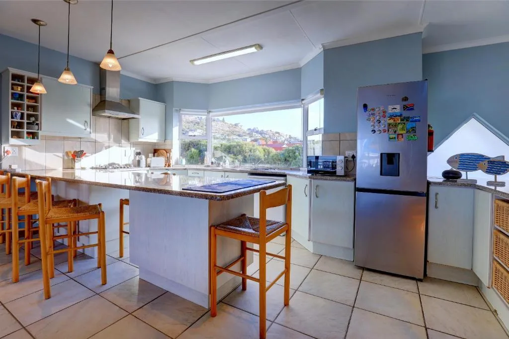 Modern kitchen with island, stainless steel appliances, and scenic mountain views
