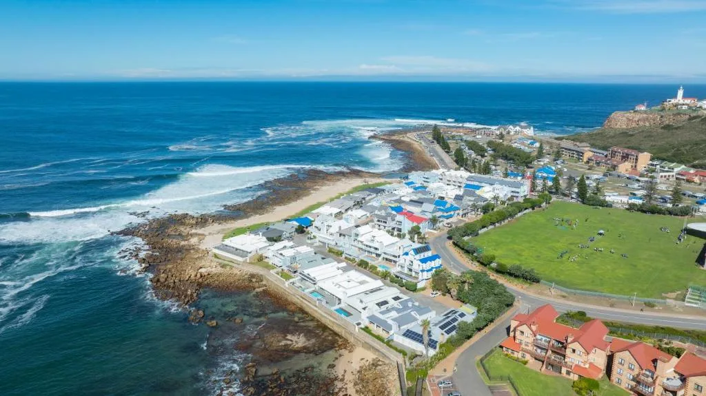 Coastal property overlooking pristine beach and rocky coastline with ocean views
