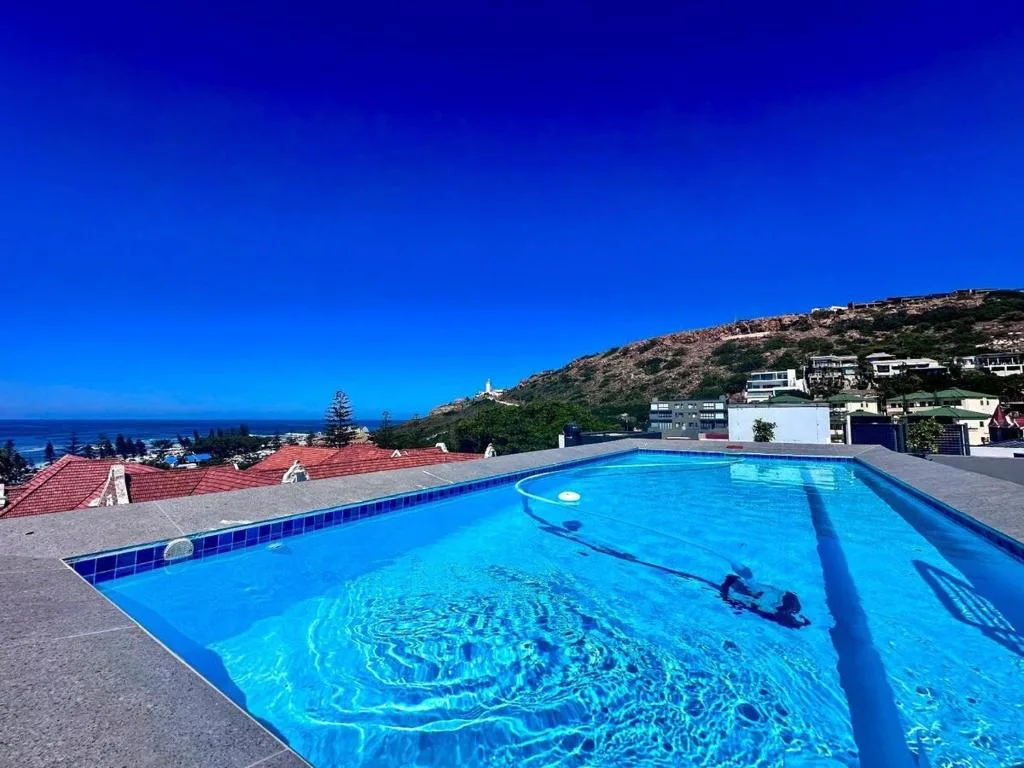 Sparkling blue swimming pool with hillside views overlooking Mossel Bay coast