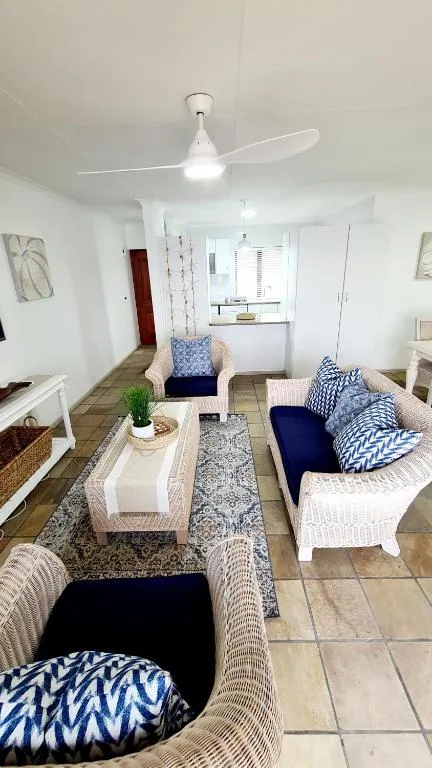 Bright living room with comfortable seating and ceiling fan