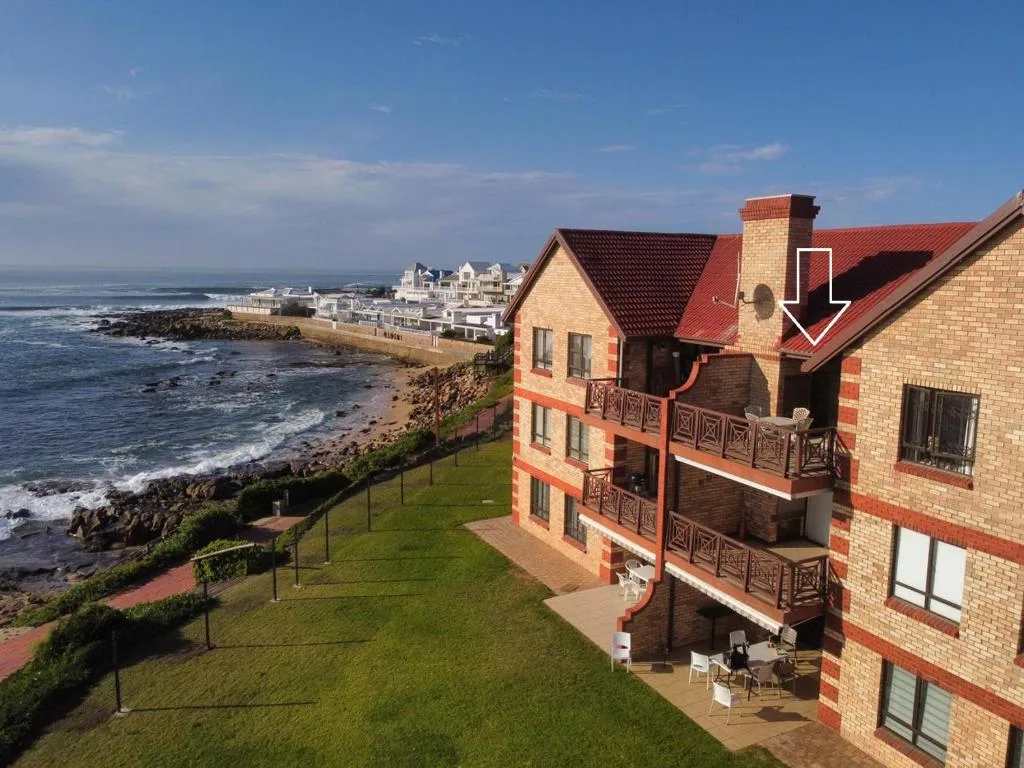 Coastal oceanfront property with rocky shoreline and ocean waves visible