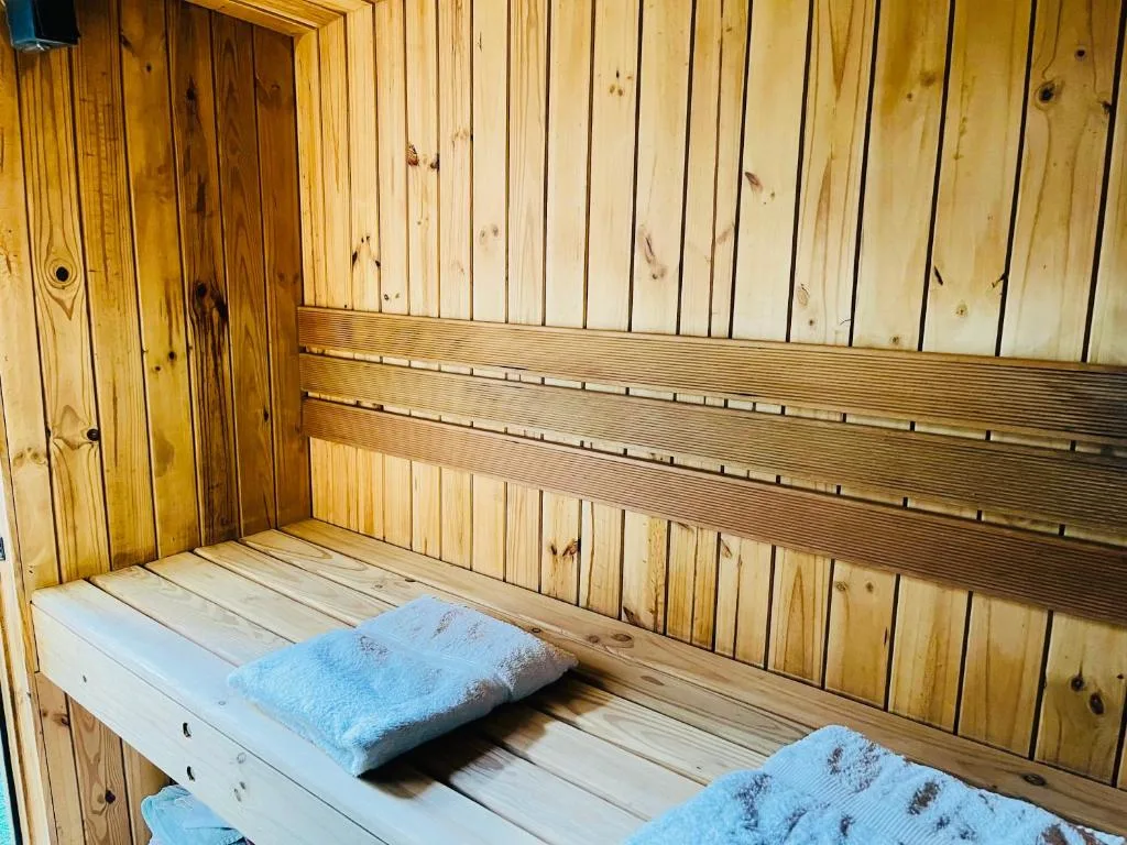 Interior wooden sauna with benches and blue towels
