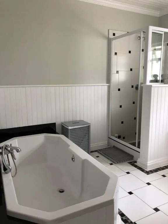 Modern bathroom with freestanding tub and glass enclosed shower cubicle