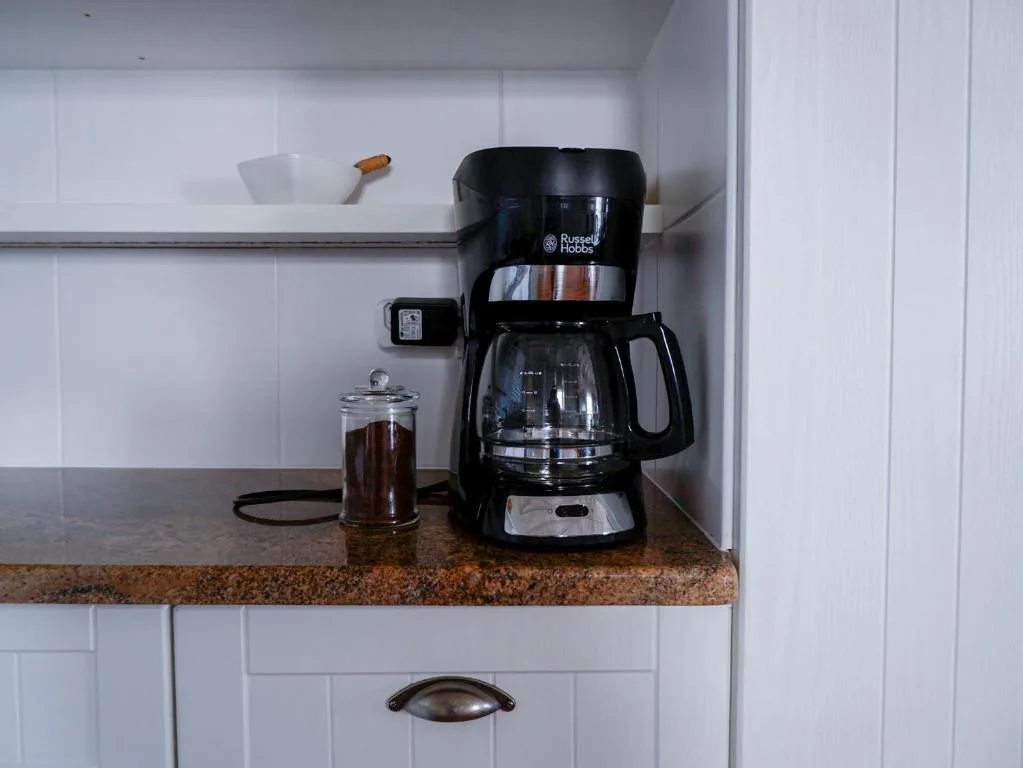 Russell Hobbs coffee maker on granite countertop with white subway tile backsplash