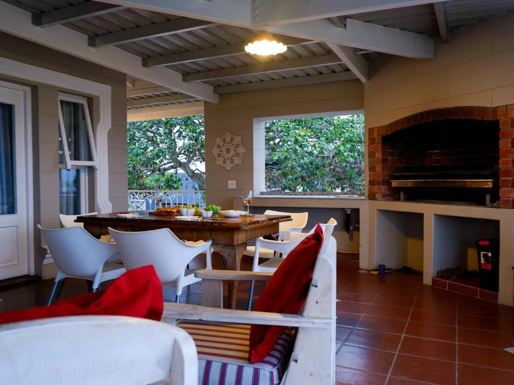 Open-plan lounge with dining area, fireplace, and garden views through windows
