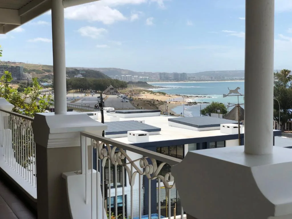 Panoramic coastal view of Mossel Bay beach and mountains from covered deck